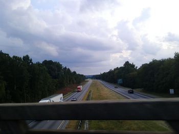 Cars on road against sky