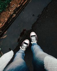 Low section of person standing in water