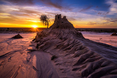 Scenic view of beach against sky during sunset