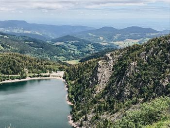 Scenic view of river and mountains against sky