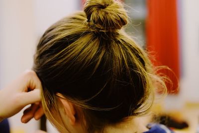 Close-up of woman with hair bun