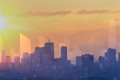 Buildings in city during sunset