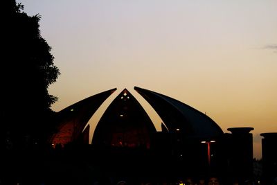 Silhouette built structure against clear sky at sunset