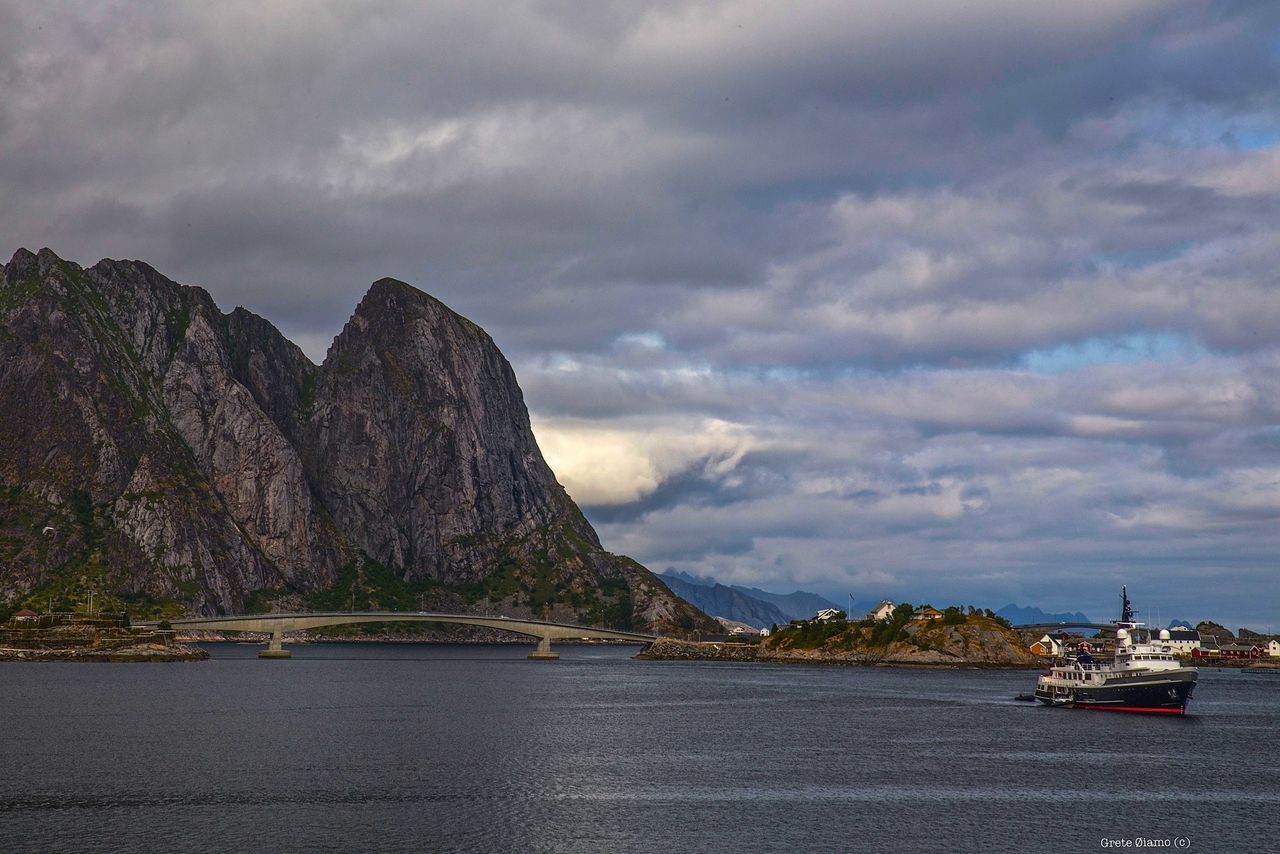 SCENIC VIEW OF SEA WITH MOUNTAIN IN BACKGROUND