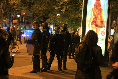 Panoramic view of people in city at night