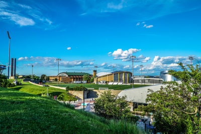 Scenic view of residential district against blue sky