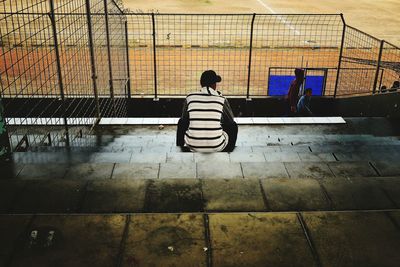 Full length of woman standing by railing