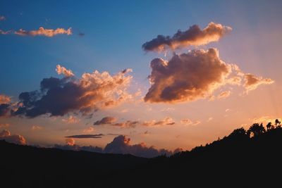 Scenic view of silhouette mountains against sky at sunset