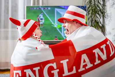 Rear view of man holding flag