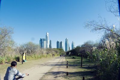 Man walking in park against clear sky