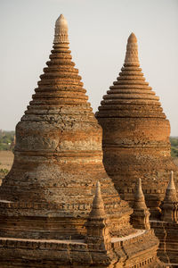Close-up of stupas against clear sky