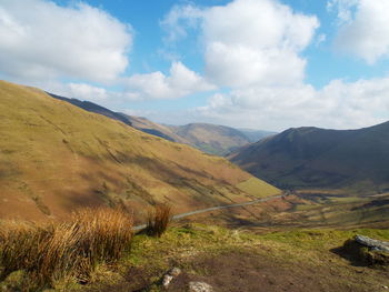 Scenic view of mountains against cloudy sky