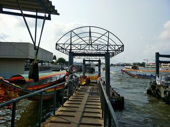 View of pier on canal against sky