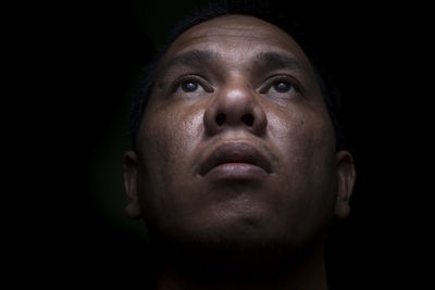 Portrait of man over black background