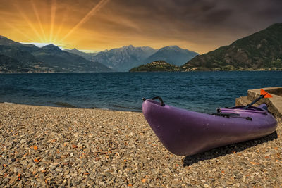 Canoe on lake como at sunset