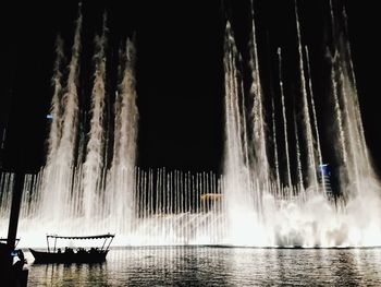 Panoramic view of boat in water at night