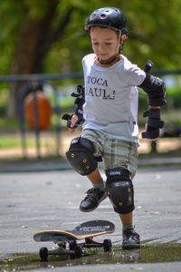 Full length of boy with arms raised