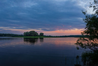 Scenic view of lake against sky at sunset