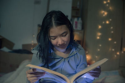 Woman reading book at home