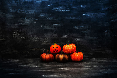 View of pumpkins on table against black background