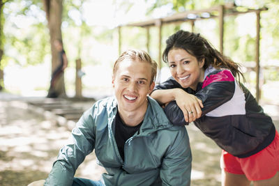 Portrait of happy multi-ethnic couple at outdoor gym