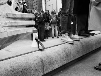 People standing on footpath during rally