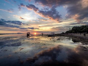 Scenic view of beach against sky during sunset