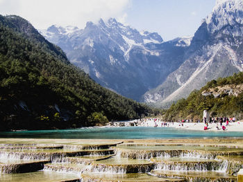 Scenic view of lake and mountains against sky