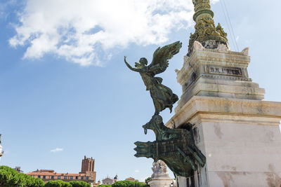 Low angle view of statue against building