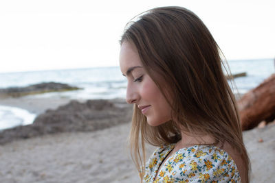 Portrait of smiling young woman on beach