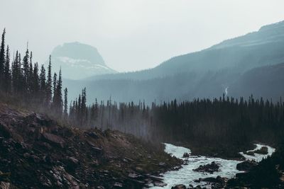 Scenic view of waterfall against sky