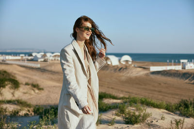 Young woman standing at beach