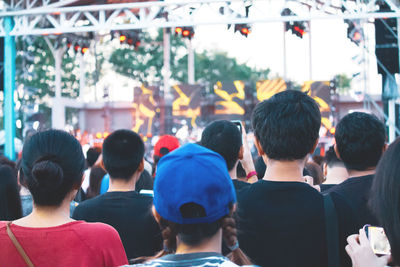 Rear view of people walking in market