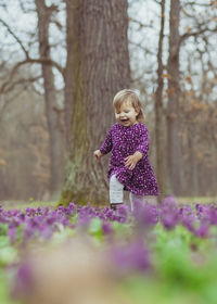 Portrait of young woman standing in park