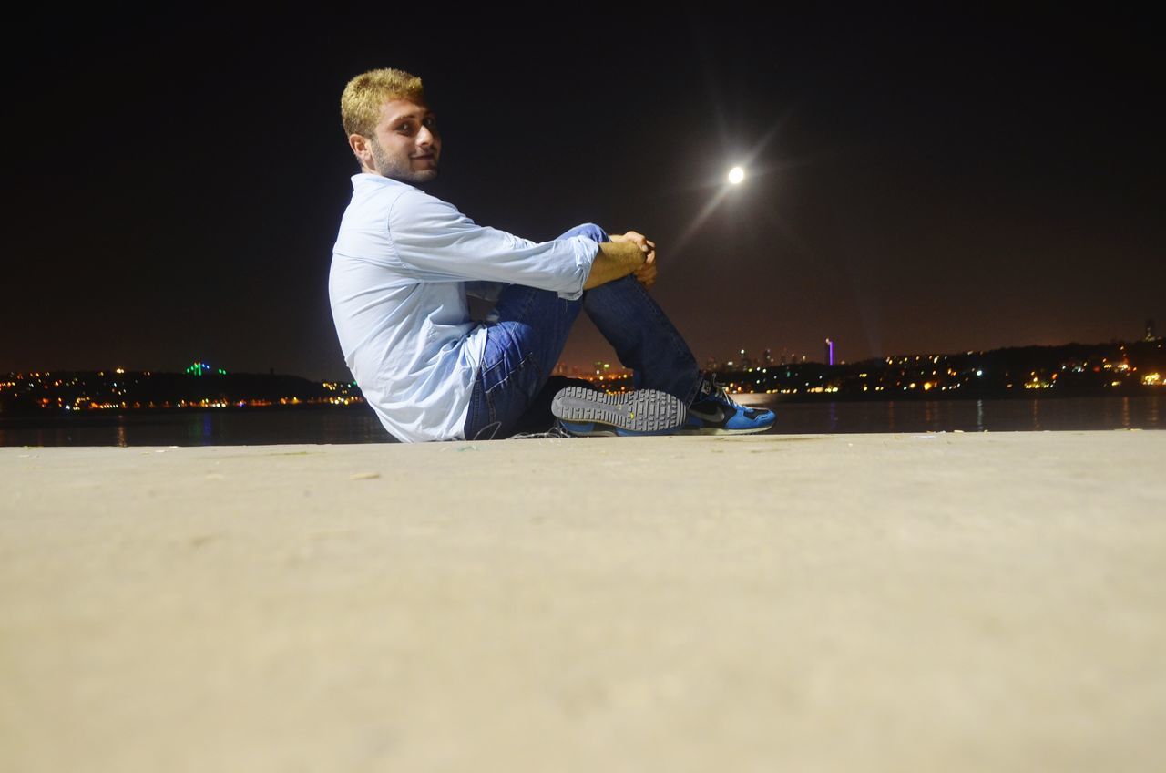 night, illuminated, lifestyles, leisure activity, full length, casual clothing, men, rear view, standing, playing, sea, copy space, beach, water, sky, young men, boys