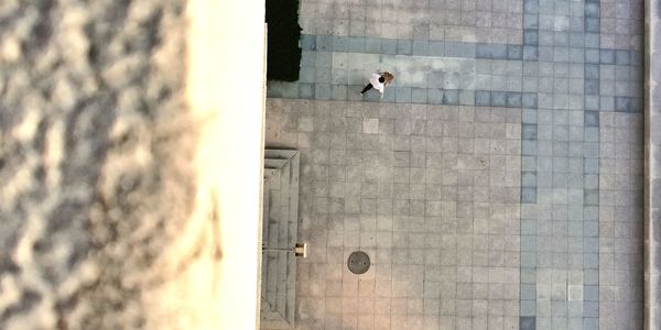 High angle view of man walking on footpath