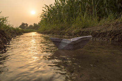 Paper boat floating on water