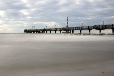 Pier over sea against sky