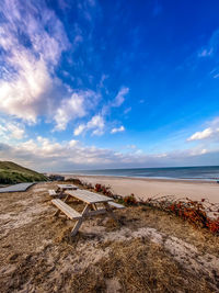 Scenic view of beach against blue sky