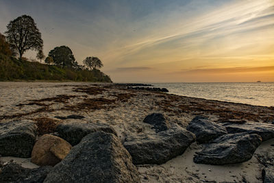 Scenic view of beach against sky during sunset