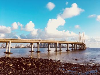 Bridge over sea against sky