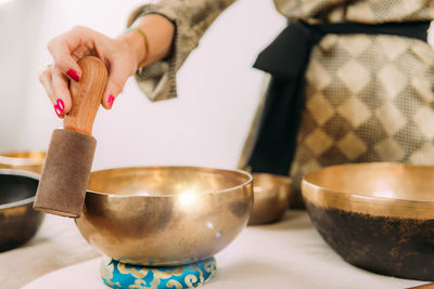 Woman playing tibetan singing bowl in sound healing therapy