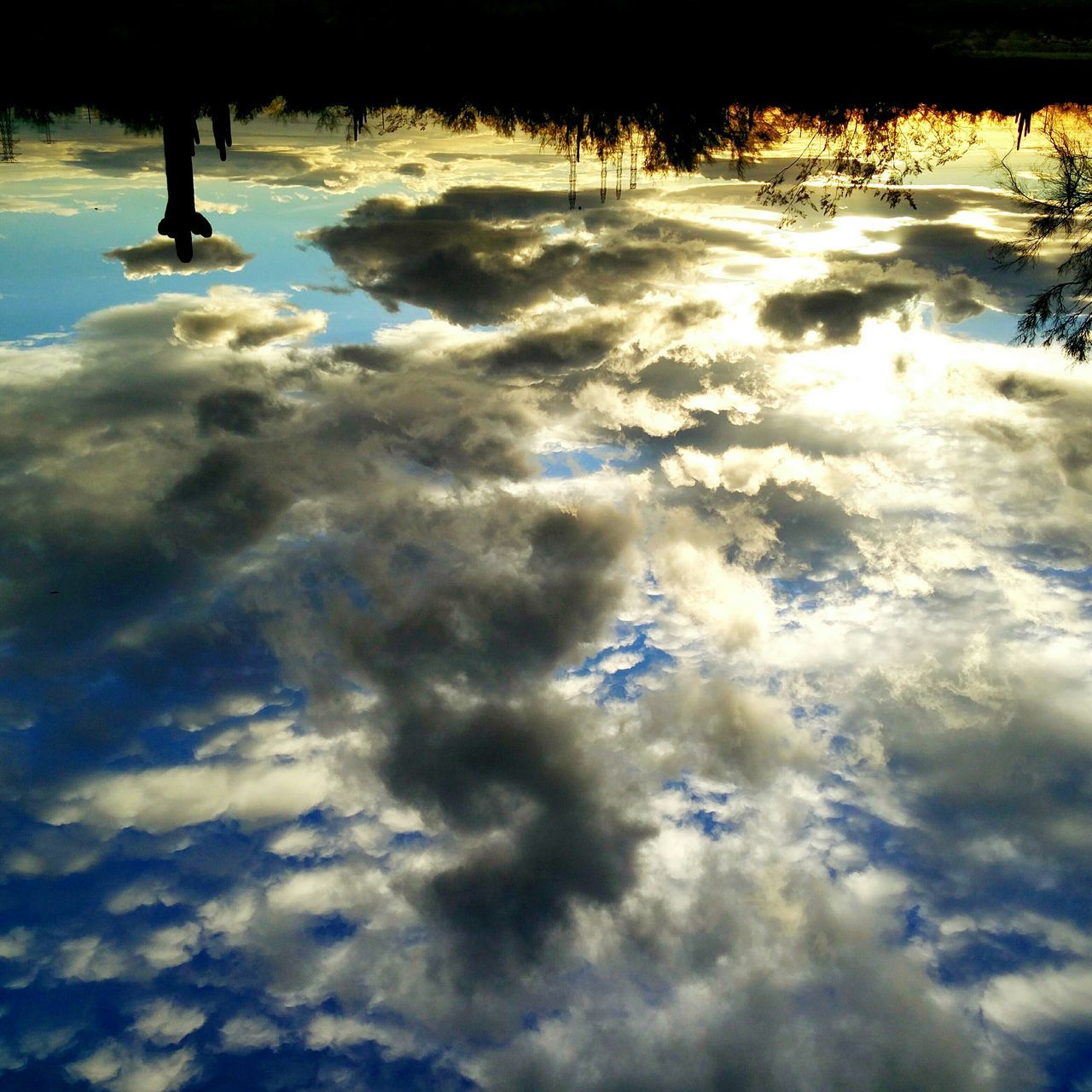 water, reflection, tranquility, lake, sky, cloud - sky, nature, tranquil scene, beauty in nature, high angle view, waterfront, scenics, outdoors, standing water, sunset, silhouette, no people, puddle, weather, idyllic