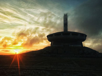 Low angle view of tower against sky during sunset