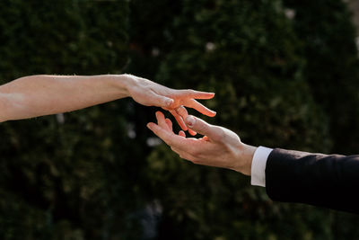 Cropped hand of man with arms raised