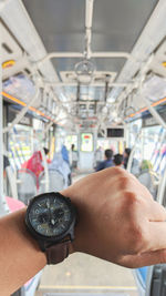 Cropped hand of man holding steering wheel