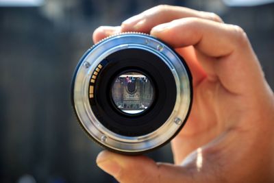 Close-up of man holding lens