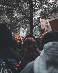 Rear view of people against plants