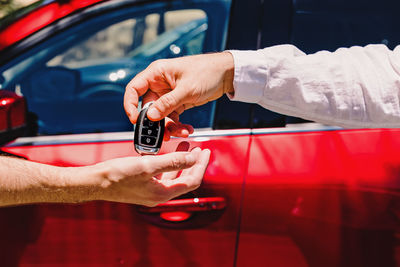 Cropped hand of man repairing car