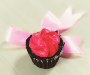 Close-up of pink rose on table